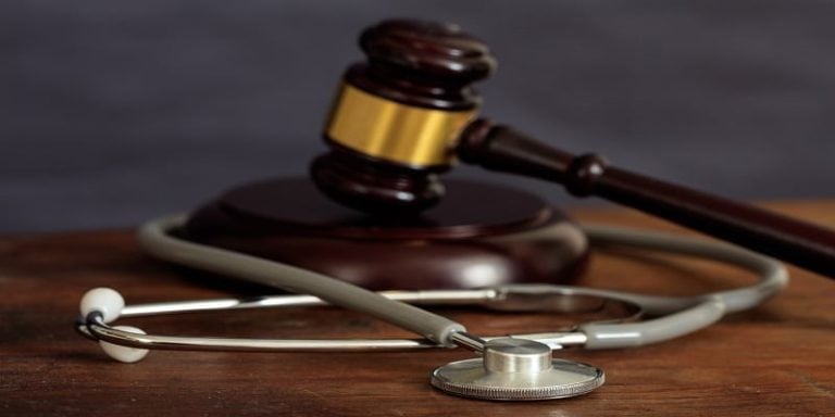 A gavel and a stethoscope rest on a wooden surface, symbolizing the intersection of law and medicine, echoing the expertise of a Trenton Medical Malpractice Attorney.