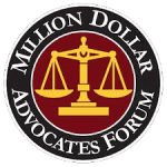 Logo of the Million Dollar Advocates Forum; features a golden balance scale on a red circle with text "Million Dollar Advocates Forum" around it.