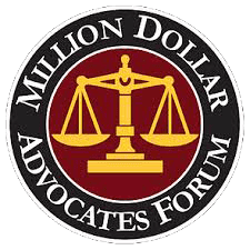 Logo of the Million Dollar Advocates Forum; features a golden balance scale on a red circle with text "Million Dollar Advocates Forum" around it.
