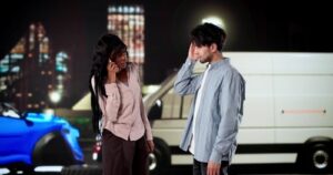 woman calling for help beside injured man holding head near vehicles at night